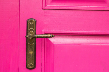 vintage wooden pink door with metal furniture