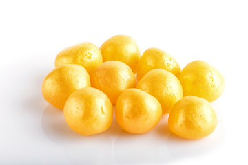 Heap of yellow hard sugar candies.
