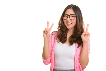 Young happy Asian woman giving peace sign