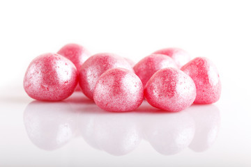 Heap of pink hard sugar candies.