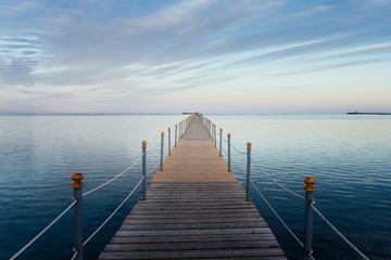 Obraz premium Pier in the Red sea in resort at sunset. Summer vacation on Red sea.