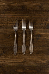 Set of vintage forks on a wooden background
