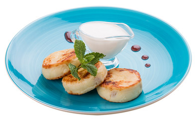 Breakfast. Cheesecakes with sour cream on a blue plate