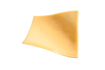 Yellow cheese slices isolated on white background.