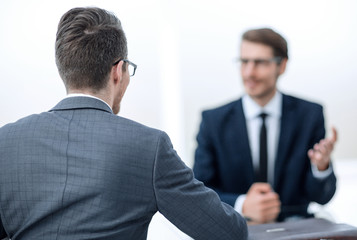 Fototapeta premium business partners talk sitting at a Desk