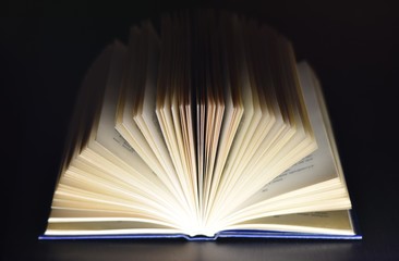 closeup opening book black background