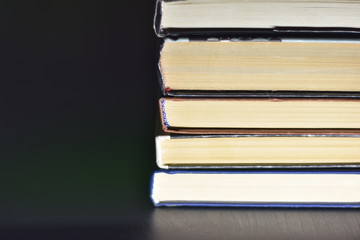 stack of books on black background