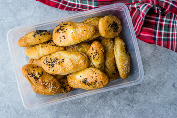 Homemade Turkish Pastry Pogaca with Cumin Seeds / Black Sesame and Cheese in Plastic Box / Container or Package.