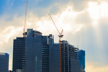Fototapeta na wymiar Crane on the construction site is a condominium, beautiful sky background.