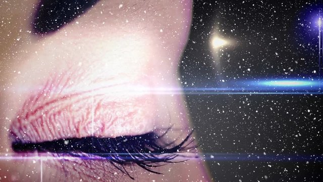 Video composition with falling snow  over close up of colorful eye
