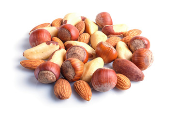 Piles of various nuts isolated on white background.
