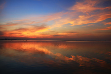 Fototapeta na wymiar natural Dramatic orange sky and reflection on sea