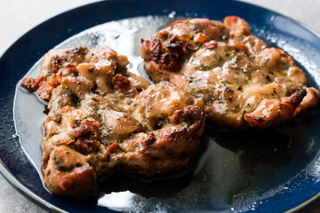 Juicy Chicken Thighs with Sauce of Thyme, Onion and Dried Tomatoes.