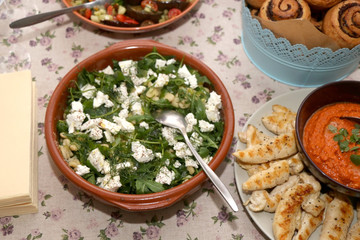 Salad with green vegetables and feta cheese, served on a table. Selective focus.