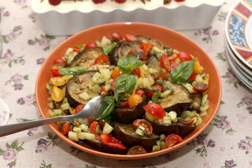 Salad with roasted aubergine and vegetables, served on a table. Selective focus.