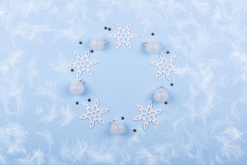 Circle round frame of Christmas decorations and snowflake on pastel blue background, flatlay, with free space for text