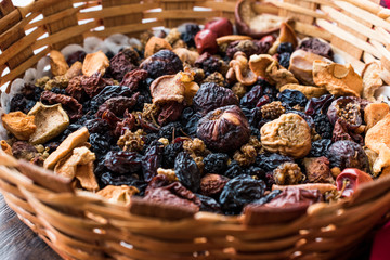 Mix of Dried Fruits; Apple, Apricot, Mulberry, Raisin, Fig, Cranberry, Raspberry and Date in Wooden Basket.