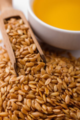 Seeds of golden flax on a white background