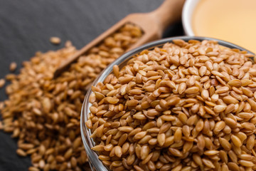 seeds of golden flax on a dark stone background