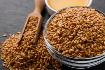 seeds of golden flax on a dark stone background