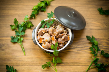 stewed chicken stomachs with vegetables and buckwheat in a bowl