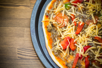 homemade pizza with forest mushrooms, peppers and tomatoes