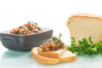 eggplant caviar with tomatoes and a slice of bread