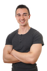smiling young man with muscular arms folded or crossed isolated on white                             