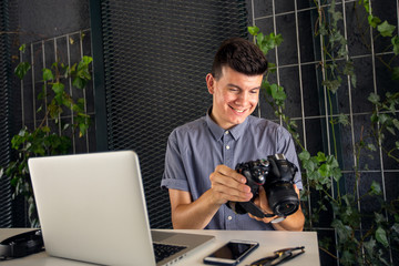 Young photographer reviewing photos on camera
