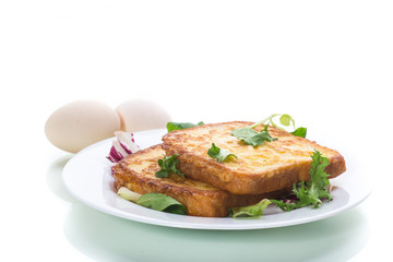 fried croutons in eggs with greens in a plate