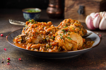 Chicken in tomato sauce with herbs and onions, cilantro parsley mint, traditional Oriental dish chakhokhbili, delicious homemade food