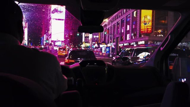colorful cinematic footage of a man driving across inner downtown Manhattan, New York, USA at night close to Times Square