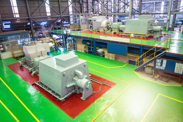 Turbine machine in power plant room to generate energy ,power electricity. Electric generators machine in sugar mill factory on production line. - Factory equipment and Industrial concept. © OAT.SAMARTKUL