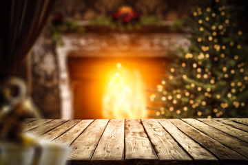 Desk of free space and home interior with fireplace and christmas tree 