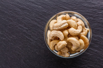 cashew nuts on a dark stone background