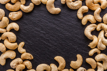 cashew nuts on a dark stone background