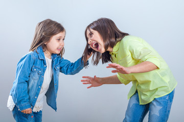 conflict between sisters, younger sister pulls the hair older sister