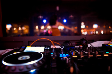 DJ sound equipment at nightclubs and music festivals, EDM, future house music and so on. Parties concept, sound technique. DJ playing on the best, famous CD players.