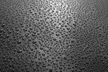Water drops on dark textured background
