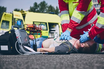 Cardiopulmonary resuscitation on road - obrazy, fototapety, plakaty