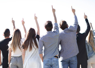 rear view. a group of business youth pointing up at a copy space