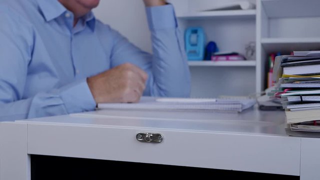 Blurred Image with Upset Businessman in Office Gesturing Nervous with a Pen