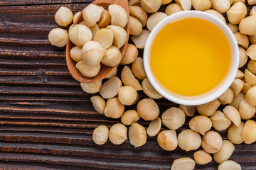 delicious macadamia nuts on a wooden rustic background