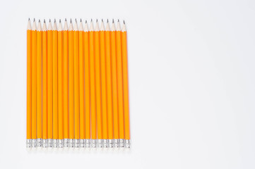 graphite pencils with rubber bands on a white background