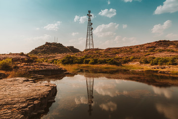 An antenna reflects on a lake in India