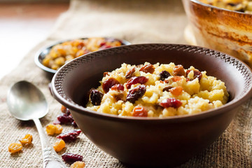 Sweet millet porridge with raisins and dried cranberries
