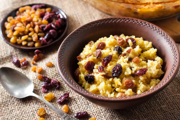 Sweet millet porridge with raisins and dried cranberries