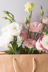 Present for birthday. Tender pink and white flowers Lisianthus, eustoma. vertical.