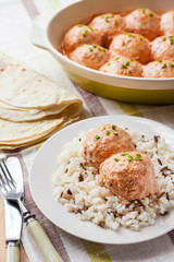 Chicken meatballs in creamy tomato sauce with rice