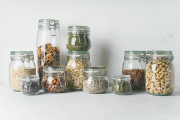 Glass jars with Superfoods nuts and cereals stacked on top of each other